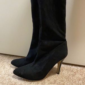 Black thigh high, high heeled boots